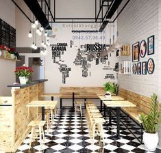 the interior of a restaurant with black and white checkered flooring, wooden tables and benches