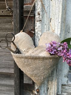 a pair of scissors hanging from a piece of burlock with flowers on it