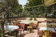 an outdoor seating area with tables and chairs