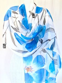 a blue and white scarf with flowers on it