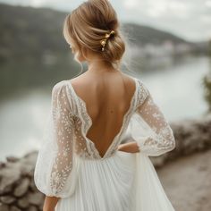 the back of a woman's wedding dress, with her hair in a bun