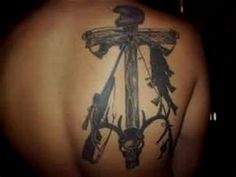 the back of a person's upper body with tattoos on their backs and arms