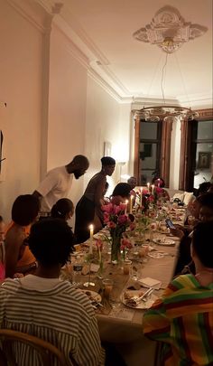 a group of people sitting around a long table