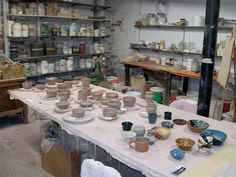 pottery is on display in an art studio