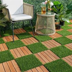 an outdoor area with grass, chairs and potted plants