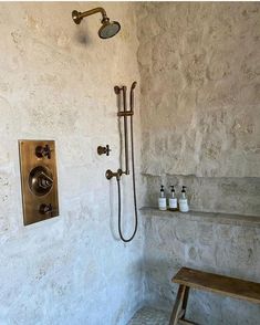 a bathroom with a shower and bench in it