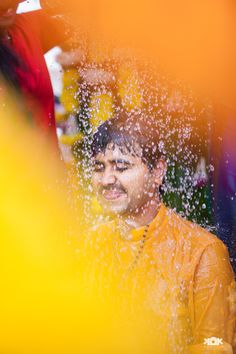 a man is covered in water as he looks at the camera