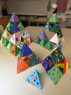 several colorful origami pyramids sitting on a table