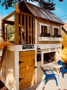 a child's play house made out of wood with a slide in the back