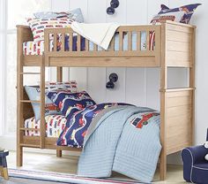 a wooden bunk bed sitting next to a blue chair in a room with white walls