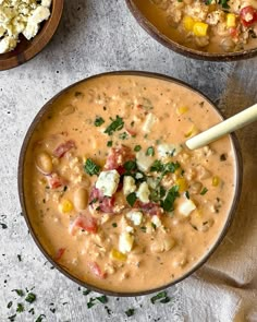 two bowls filled with soup on top of a table