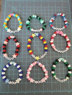 six bracelets made out of plastic beads on a cutting board