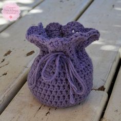 a crocheted bag sitting on top of a wooden table