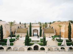 an aerial view of a building with steps leading up to it and trees in the foreground