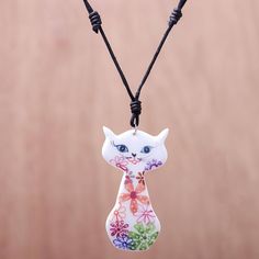 Painted by hand with colorful daisy motifs a cat is crafted of white ceramic. Thai artisan Napat Chotpruekchookul designs this necklace adorning the wearer on adjustable cotton cord. Thailand Gifts, Ceramic Pendant Necklace, Necklace Cat, Cat Pendant Necklace, Broken China Jewelry, Ceramic Workshop, Cat Themed Gifts, Floral Cat, Ceramic Necklace