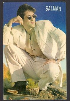 a man wearing sunglasses and a white suit is posing for a magazine cover with his hands on his hips