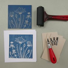 three different types of art work displayed on a table with scissors and inking supplies