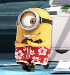 a minion is standing in front of a computer