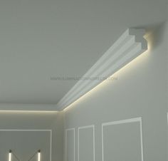 an empty room with some lights on the ceiling and white walls in front of it