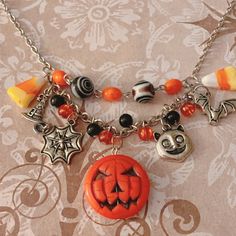 Ultimate Halloween vibes silver charm necklace featuring upcycled and new beads. A fun statement piece for spooky season. Handmade Dangle Necklaces For Halloween, Handmade Spooky Necklace For Halloween, Handmade Spooky Halloween Necklaces, Silver Charm Necklace, Diy Jewelry Necklace, Halloween Vibes, Charm Necklace Silver, Spooky Halloween, Jewelry Necklace