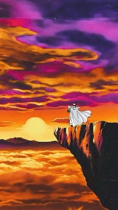 a man standing on top of a cliff in the middle of an orange and purple sky