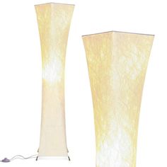 two tall white vases sitting next to each other