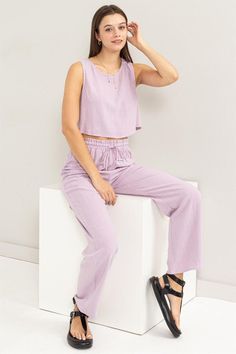 Get the ultimate comfort in our Linen Blended Top and Pants Set. Made with cotton, this set combines style and comfort. The top features a round neck and wrap-effect back, while the high-waisted pants have a drawstring closure. Model is wearing a size small Measurement from a small: Recommended sizing 2-4 S, 6 M, 8-10 L Fabric Contents: 100% Cotton Length for the top: 15" Size Measurement (inch): S: 16.0 (Bust), 12.5 (Waist), 19.0 (Hips), 39.0 (Length) M: 16.5 (Bust), 13.0 (Waist), 19.5 (Hips), Loungewear Two-piece Pants Set, Casual Loungewear Two-piece Pants Set, Chic Loungewear Sets With Elastic Waistband, Cropped Two-piece Loungewear Set, Solid Cropped Loungewear Pants, Cropped Two-piece Set Tops For Loungewear, Solid Cropped Pants For Loungewear, Spring Casual Loungewear Co-ords, Casual Spring Loungewear Co-ords