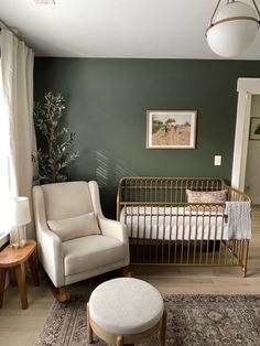 a baby's room with a crib, rocking chair and footstool