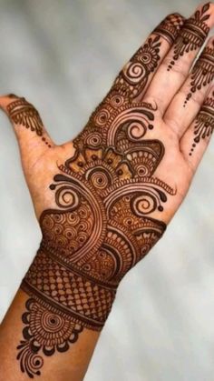 a hand that has some henna on it