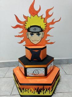 this is a three tiered cake made to look like naruto