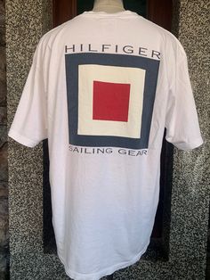 "Vintage Tommy Hilfiger Sailing Gear T shirt item condition : pre owned (used ) Condition : please see picture Size in tag : L  tag  : tommy measurement chest (Pit to pit ) 23\" Length 29\" shipping : world wide Standard shipping : 14 - 30 days Express : 5-10 days I can do bundle/combined shipping add USD 5 shipping for each additional items" Nautical Cotton T-shirt With Graphic Print, Nautical Cotton T-shirt With Short Sleeves, Nautical Style Cotton T-shirt With Short Sleeves, White Nautical Style Short Sleeve T-shirt, White Nautical Short Sleeve T-shirt, White Short Sleeve Nautical T-shirt, Nautical Short Sleeve Cotton Tops, Nautical Short Sleeve Cotton Shirt, White Short Sleeve Nautical Shirt