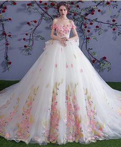 a woman in a wedding dress with flowers on it