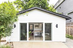 a small white house with sliding glass doors