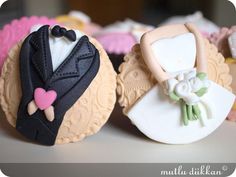 wedding cupcakes are decorated with bride and groom's dress on them,