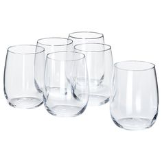 four clear wine glasses lined up next to each other