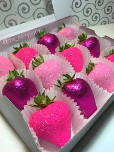 pink and purple strawberries in a box with glitter on the top are ready to be eaten