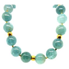 This stunning necklace features an impressive collection of large, 16mm round aquamarine beads with lovely, natural sea foam green color! The beads are beautifully matched, varying from pastel to deeper shades of a gorgeous and versatile color that looks "bluer" when worn with blue, "greener" when worn with green! 18k yellow gold beads and accents elevate this gemstone necklace to fine jewelry status and make it a perfect complement to both warm and cool tones. This necklace pairs beautifully with casual and dressy attire, and will transition easily between daytime and evening wear. Hand strung on silk thread and finished with a lovely 18k yellow gold clasp, this necklace measures 20 inches in length. Original, beautiful, and timeless! Jean Art, Green Aquamarine, Dressy Attire, 1st Dibs, Jewelry Girl, Vintage Beads Necklace, Aquamarine Beads, Yellow Gold Necklace, Chunky Jewelry