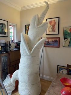 a large white sculpture sitting on top of a wooden table