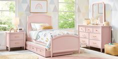 a child's bedroom with pink furniture and accessories