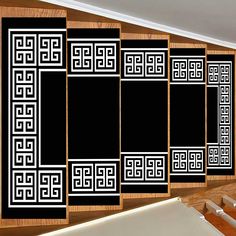 an image of a room divider with black and white designs on the wall behind it