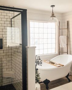 a white bath tub sitting next to a window