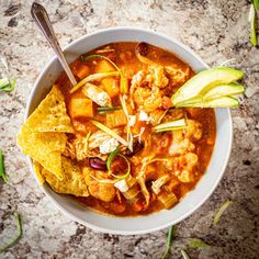 a white bowl filled with chicken tortilla soup