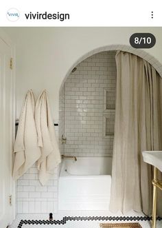 a white bathroom with black and white checkered flooring, shower curtain, and bathtub