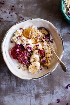 a white bowl filled with oatmeal and fruit