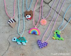 several necklaces made to look like animals and cars are on the ground next to each other