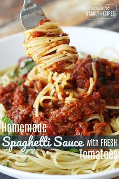 homemade spaghetti sauce with fresh tomatoes and parmesan cheese is being lifted from a white bowl