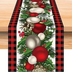 a christmas table runner with ornaments on it