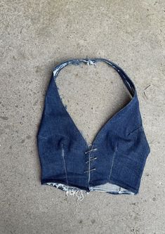 Denim, we love it. The Phobya Halter, in original indigo denim! - just in time for summer. Hand crafted from top-quality sustainable denim and completely unique. Finished with the statement Safety Pin Closure and adjustable neck strap.  This top is designed to be uniquely worn, adjusting the pins to the wearer. - Safety Pin closure - Handmade  - One piece halter-neck and waistcoat design - Fitted waist - Cropped length - Pre-washed   - Sustainable dead-stock denim  - Available in black and blue Fitted Washed Blue Cotton Jeans, Washed Blue Recycled Denim Jeans For Summer, Fitted Cutoff Denim Jeans, Cutoff Denim Jeans For Festival, Light Indigo Washed Jeans For Summer, Summer Washed Blue Rigid Denim Jeans, Washed Blue Rigid Denim Jeans For Summer, Fitted Cotton Cutoff Top, Fitted Recycled Denim Jeans In Denim Blue