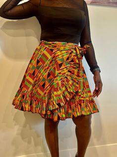 Relax in the beauty of African history with our stunning Kente wrap skirt. Crafted from the finest Kente fabric, this masterpiece has complex designs and brilliant colours that represent grandeur and prestige. Whether you like the classic beauty of a maxi, the whimsical appeal of a mini, or the elegant allure of a midi, our Kente wrap skirts are a tribute to African culture. The wrap design flatters every form, and the sumptuous Kente fabric drapes elegantly. Elevate your wardrobe with this striking item that flawlessly combines heritage and current design. Experience the beauty of Kente and create a striking fashion statement. Features:  ✨Kente fabric, wrap style, versatile length options, handcrafted details. ✨Perfect for Special occasions, cultural events, and evening wear. ✨Pair with a Traditional Long Skirt With Ruffles, Traditional Fitted Tiered Skirt, Fitted Long Wrap Skirt With Ruffles, Traditional Fitted Long Wrap Skirt, Multicolor Fitted Long Wrap Skirt, Fitted Traditional Long Wrap Skirt, Fitted Bohemian Pleated Mini Skirt, Orange Ruffled Flowy Skirt, Traditional Full Gathered Skirt