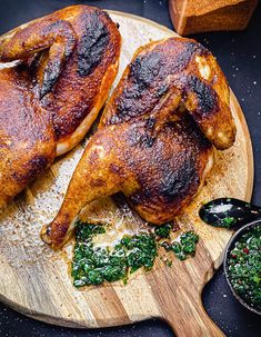 two pieces of chicken on a cutting board